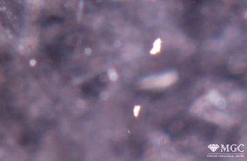 Bread crumb inclusions in synthetic amethyst. View mode - dark lighting