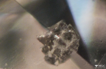 Crystal inclusions in natural diamond. View mode - dark-field lighting.