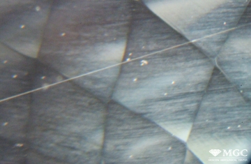 Tubular inclusions in natural topaz. View mode - dark lighting.