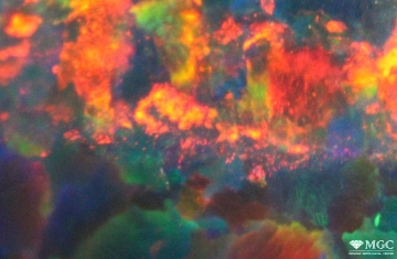 Мелкоточечные цветовые пятна с гранулированным рисунком типа "кожа змеи" в синтетическом опале. Режим просмотра - отражённый свет.