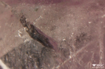 The distribution of the dye in the crack in natural colored quartz. View mode - dark lighting.