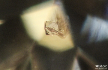 The inclusion of the type "diamond in diamond" with a concomitant crack in a natural diamond. View mode - dark lighting.