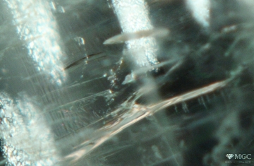 Disc-shaped inclusions in natural emerald (Emerald mines region, Ural). View mode - dark lighting.