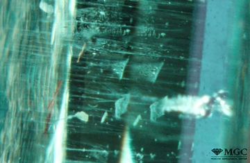 Veils of two-phase inclusions in synthetic emerald. View mode - dark lighting.