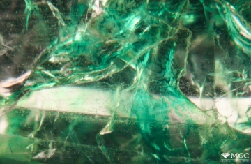 Filling of cracks in quartz with colored material imitating emerald. View mode - dark lighting.