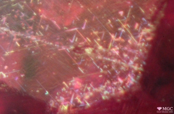 Inclusions of rutile ("rutile silk") in a non-refined ruby (deposit of Mogok district, Burma). View mode - reflected light.