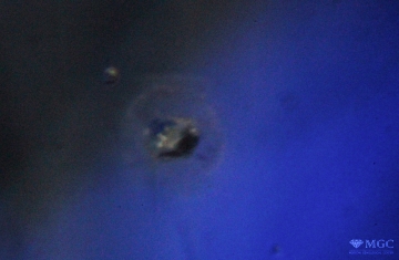 Destroyed mineral inclusion in heat-treated sapphire. View mode - dark lighting.