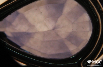 Uneven distribution of color in diffusion-colored sapphire, formed as a result of unequal removal of the colored surface layer. View mode - diffused transmitted light.