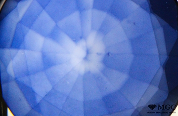 Uneven distribution of color in synthetic diffusion colored sapphire. View mode - transmitted light.
