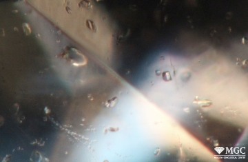 Mineral inclusions in natural aquamarine. View mode - dark field lighting.